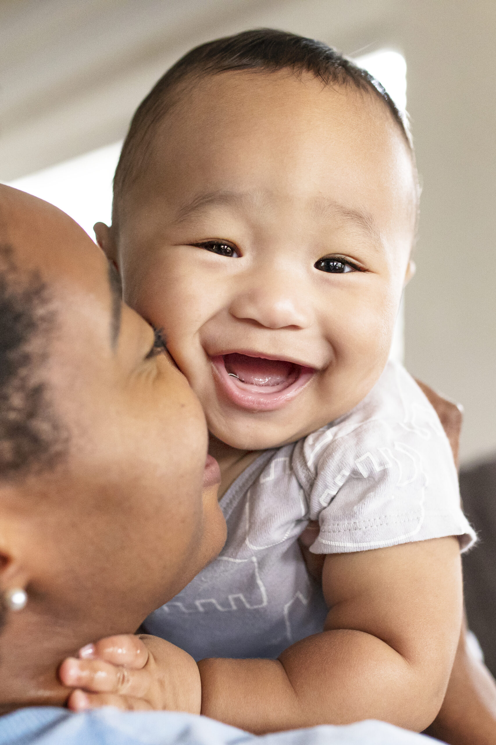 Home african american mother kissing her son